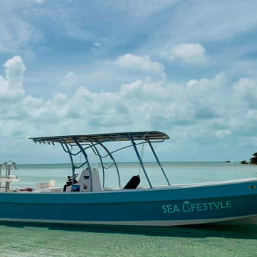 A private charter boat in turquoise water off Caye Caulker, Belize